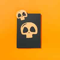 Free photo two skulls laid on piece of black paper