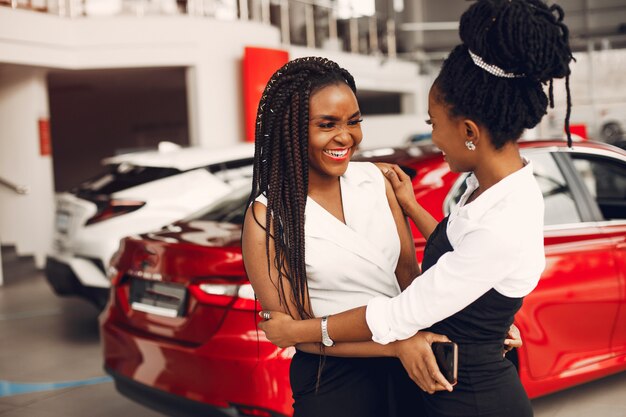 Two stylish black women in a car salon