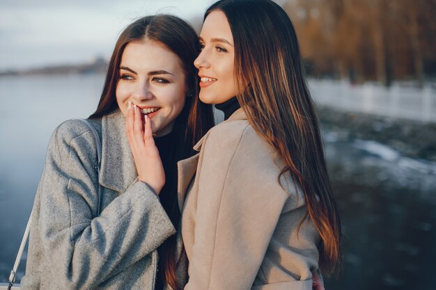 Two stylish girls have a rest in a city