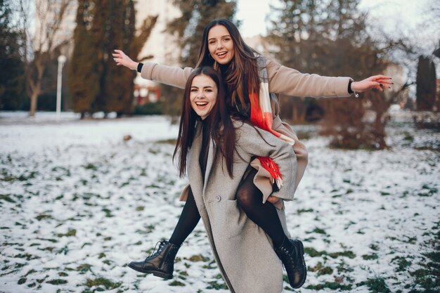 Two stylish girls have a rest in a city