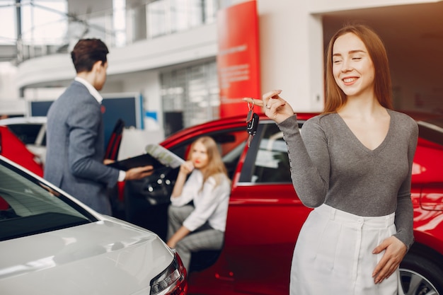 Two stylish woman in a car salon