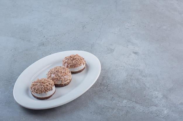 Free photo two tasty truffle balls placed on white plate.