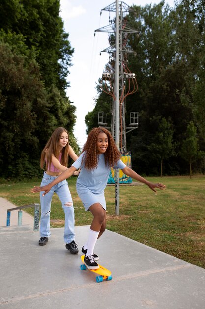 Two teenage girls spending time together at the skating rink