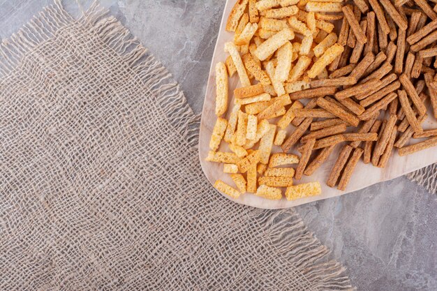 Two types of crackers on wooden board