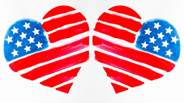 Two usa flag painted heart shapes on white background