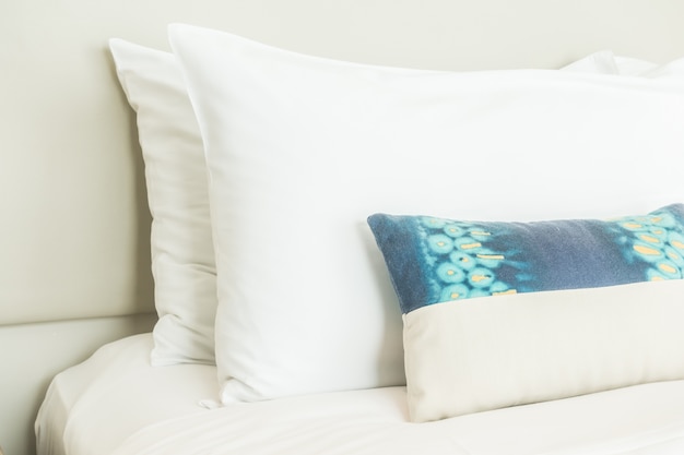 Free photo two white pillows and one blue cushion