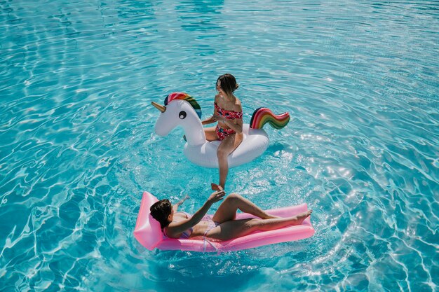 Two woman relaxing  in pool