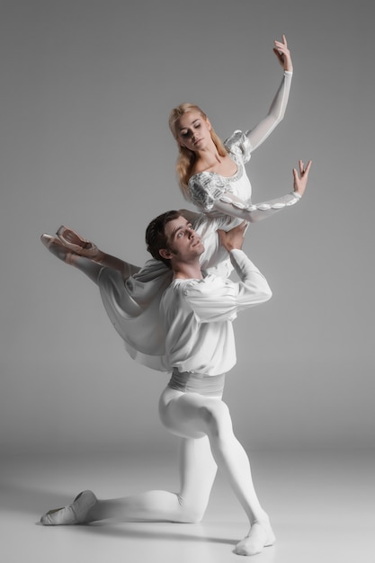 Free Photo two young ballet dancers practicing. attractive dancing performers  in white