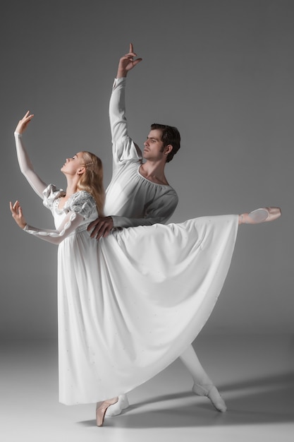 Free Photo two young ballet dancers practicing. attractive dancing performers  in white