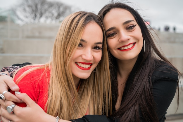 Two young friends hugging each other.