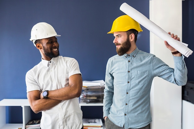 Two young male happy architects making fun in the office