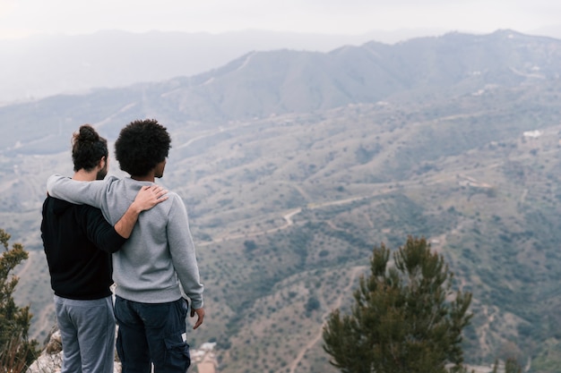 Two young men over looking the mountain landscape