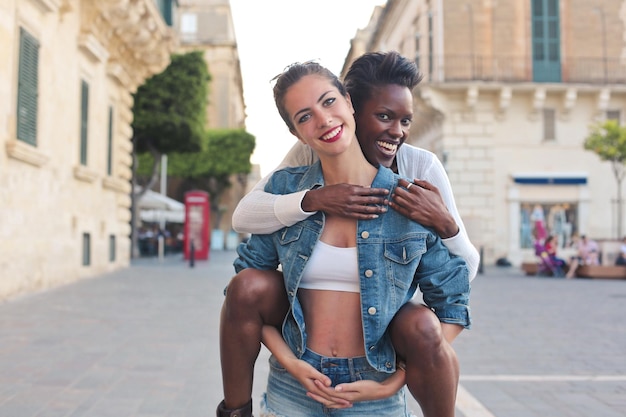 two young women embraced in the street