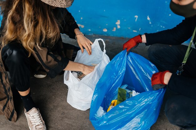 Two young women sorting garbage. Concept of recycling. Zero waste