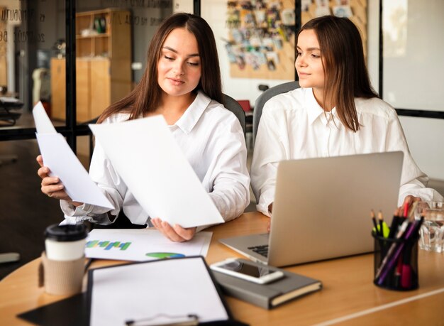 Two young women at work collaborating