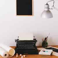 Free photo typewriter and office supplies on table