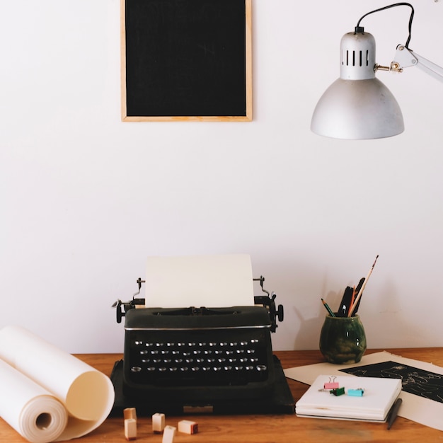 Free Photo typewriter and office supplies on table