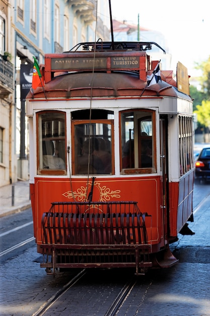 Typical red Tram in old Lisbon street