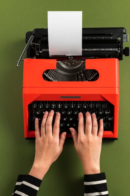 Typing on a red retro typewriter blank paper