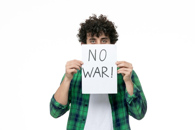 Free Photo ukraine russian conflict cute guy holding no war sign covering face