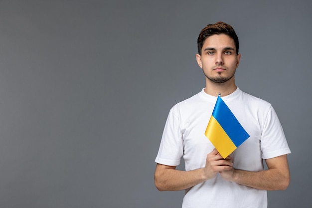 Ukraine russian conflict cute handsome guy in white shirt with praying for ukraine