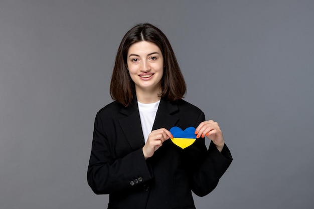 Free Photo ukraine russian conflict cute young dark hair woman in black blazer brave with heart