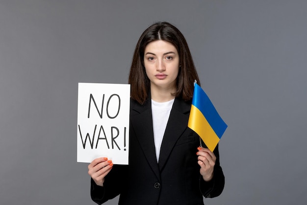 Free Photo ukraine russian conflict cute young dark hair woman in black blazer with no war sign and flag