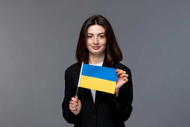 Ukraine russian conflict dark hair cute young woman in black blazer proud of ukraine