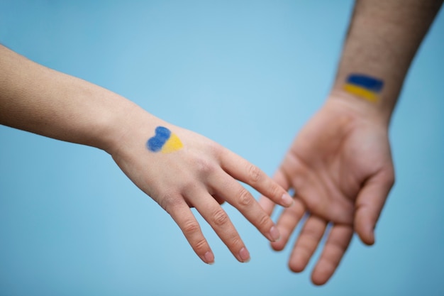 Ukrainian flags on hands