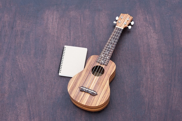 Free Photo the ukulele with the notebook