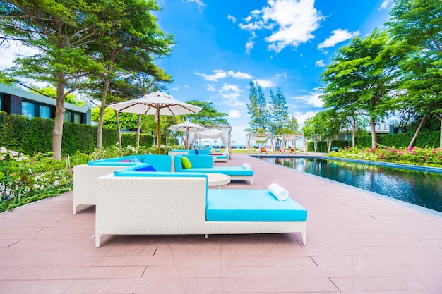 Free photo umbrella and chair around swimming pool