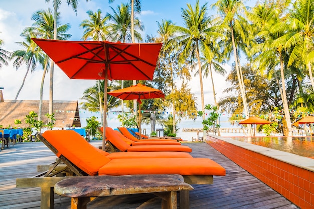 Umbrella and chair around swimming pool