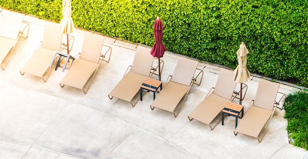 Free Photo umbrella chair around swimming pool