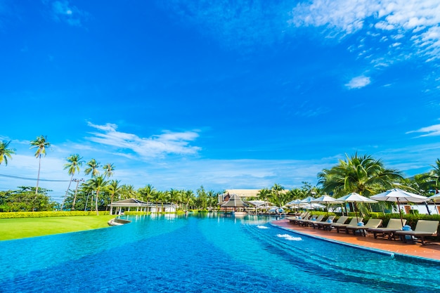 Umbrella and chair around swimming pool