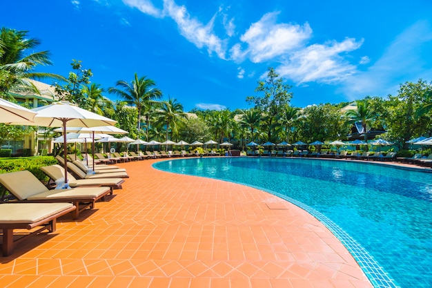 Umbrella and chair around swimming pool