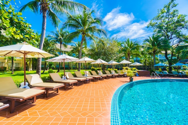 Umbrella and chair around swimming pool