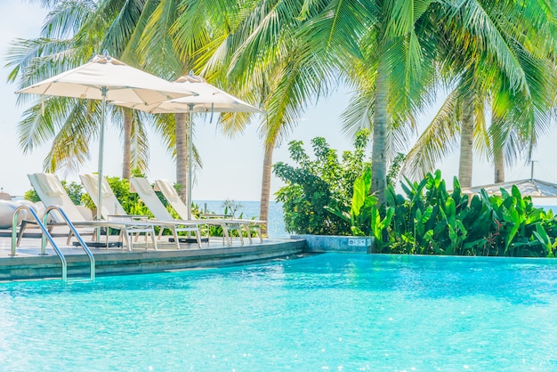 Free Photo umbrella with chair in hotel pool resort