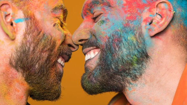 Unclean faces gay couple enjoying each other