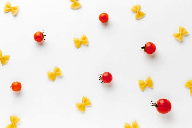 Uncooked farfalle arrangement with tomatoes