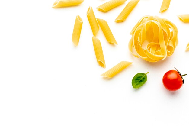 Uncooked penne and tagliatelle with copy space