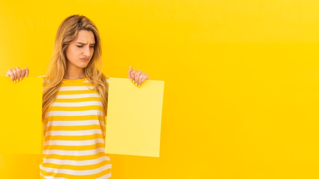 Free photo undecided woman holding papers