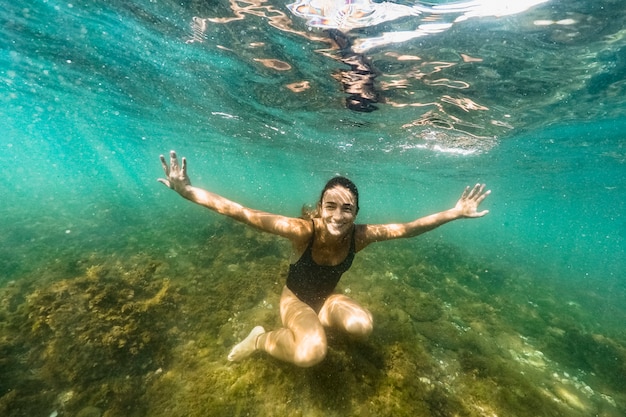 Free photo underwater shot of woman diving