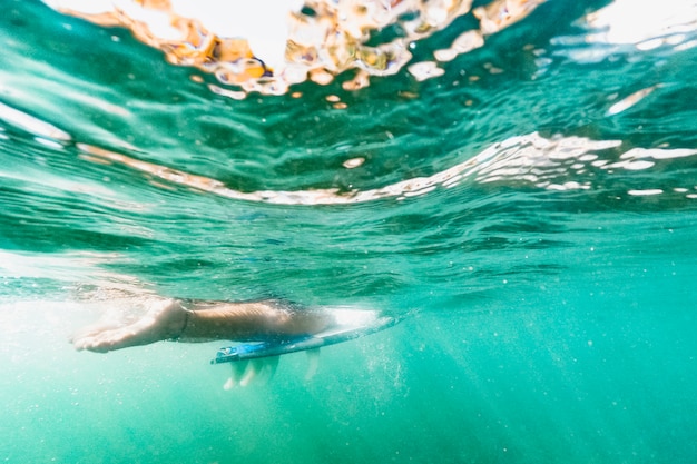 Free photo underwater shot of woman with surfboard