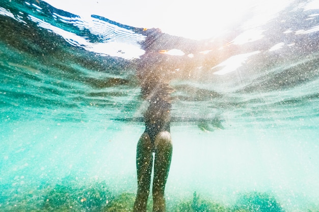 Free photo underwater shot of woman with surfboard