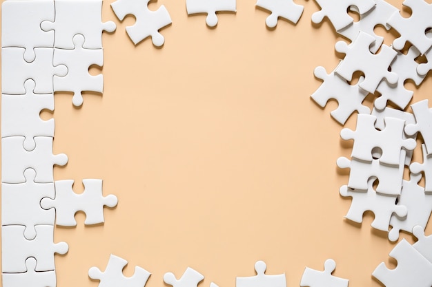 Free photo unfinished white jigsaw