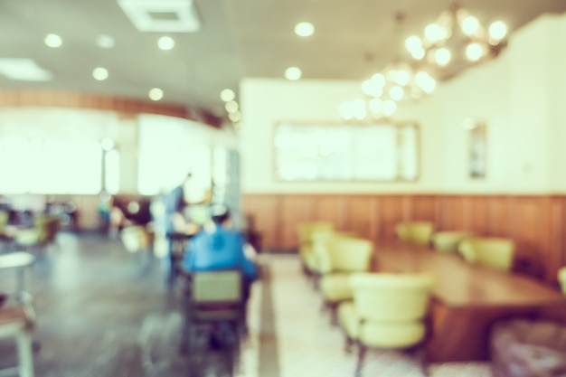 Unfocused restaurant with green chairs