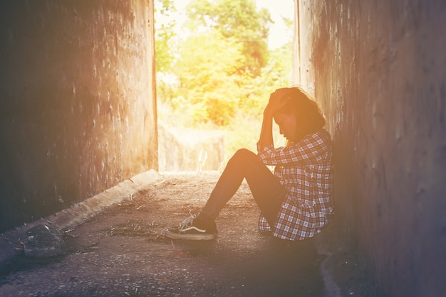 Unhappy girl sitting on the floor