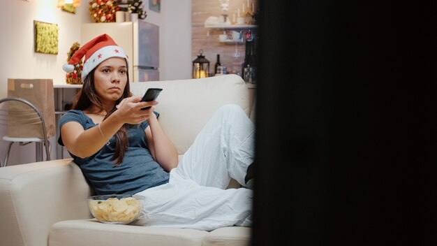 Unhappy person using tv remote control to switch channels