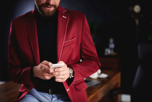 Unrecognizable businessman using smartphone in office