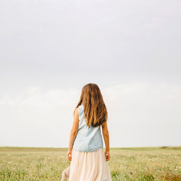 Free Photo unrecognizable girl standing in field